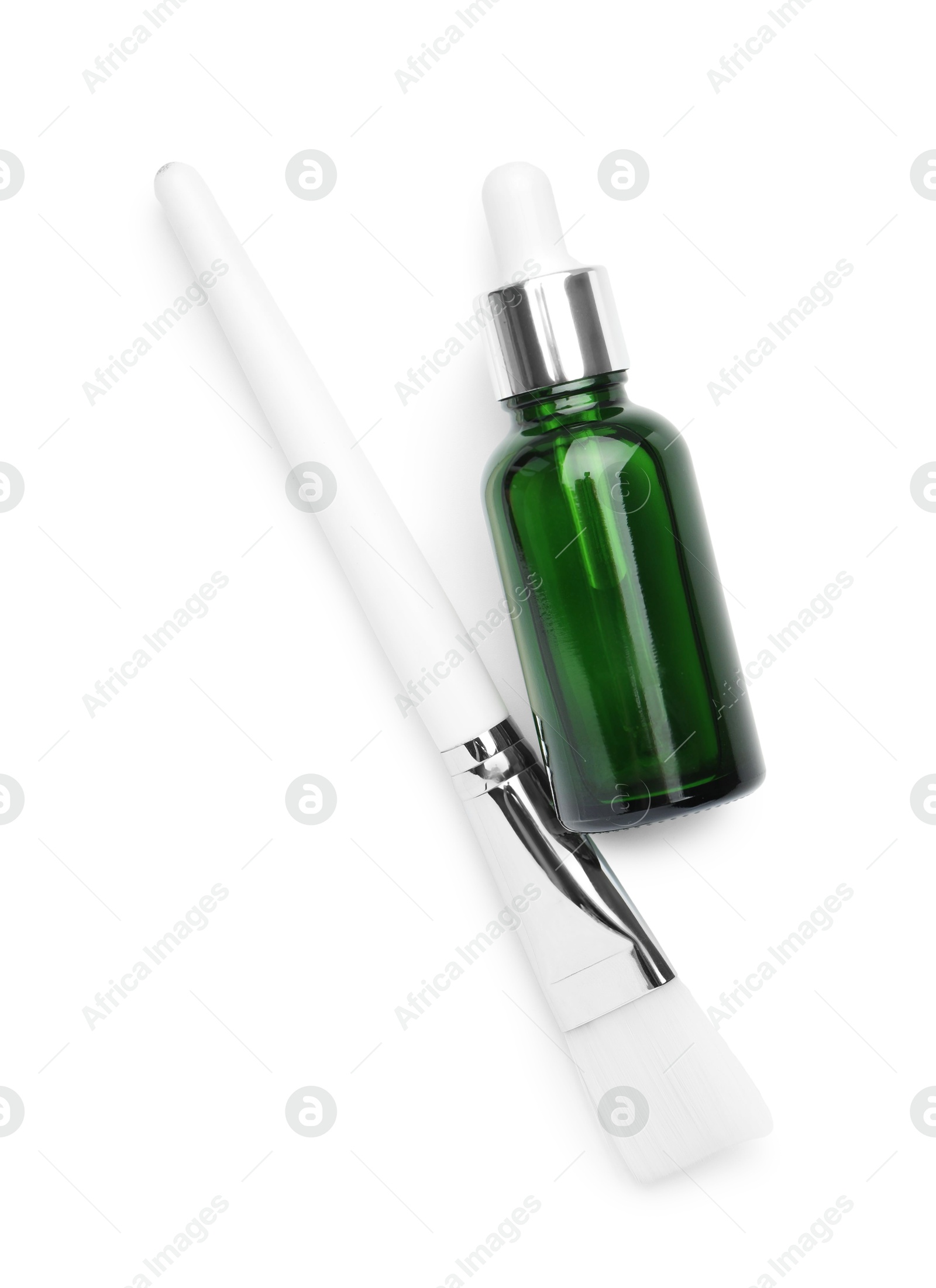 Photo of Bottle of chemical peel and brush isolated on white, top view. Peeling procedure