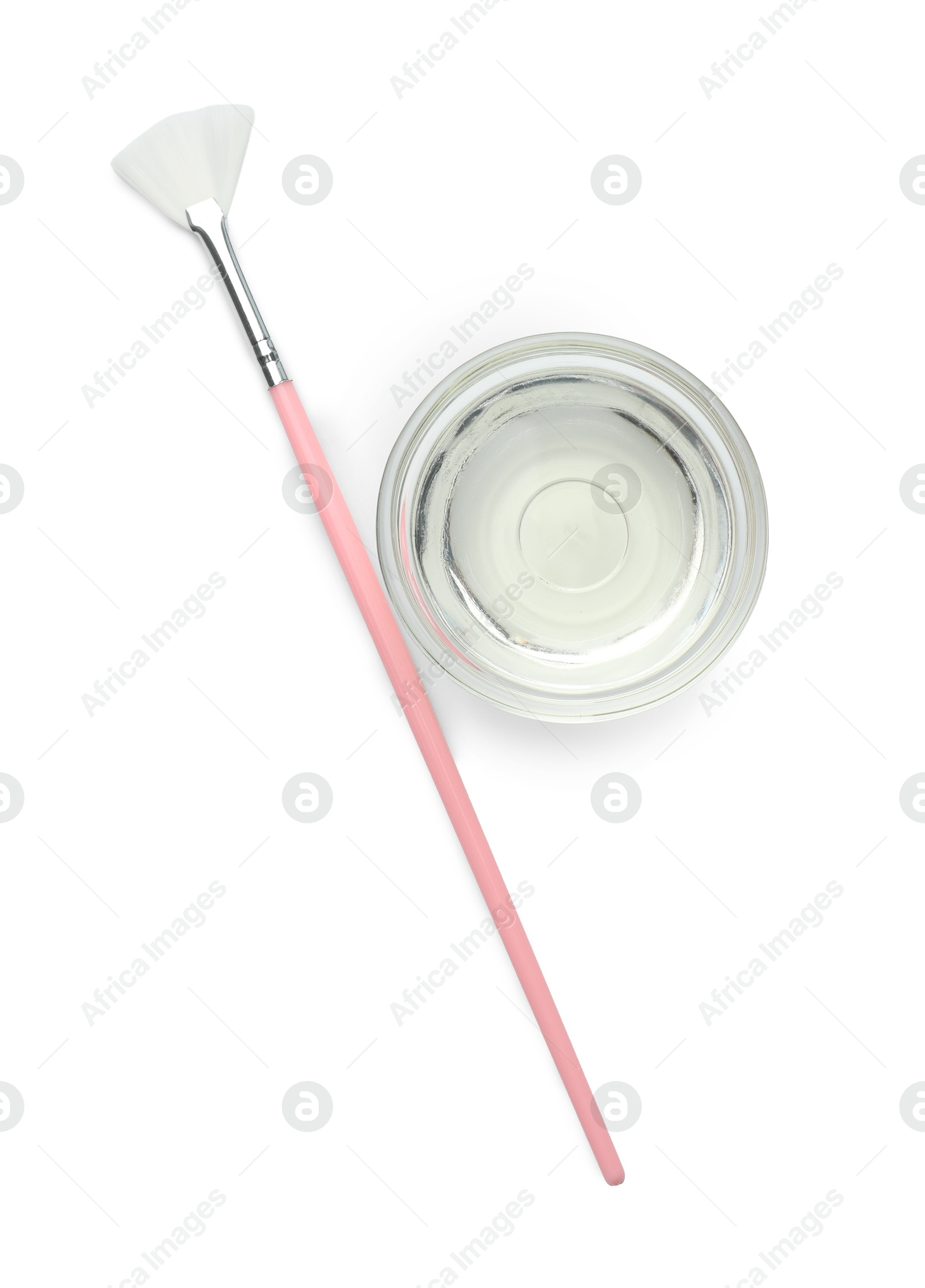 Photo of Bowl of chemical peel and brush isolated on white, top view. Peeling procedure