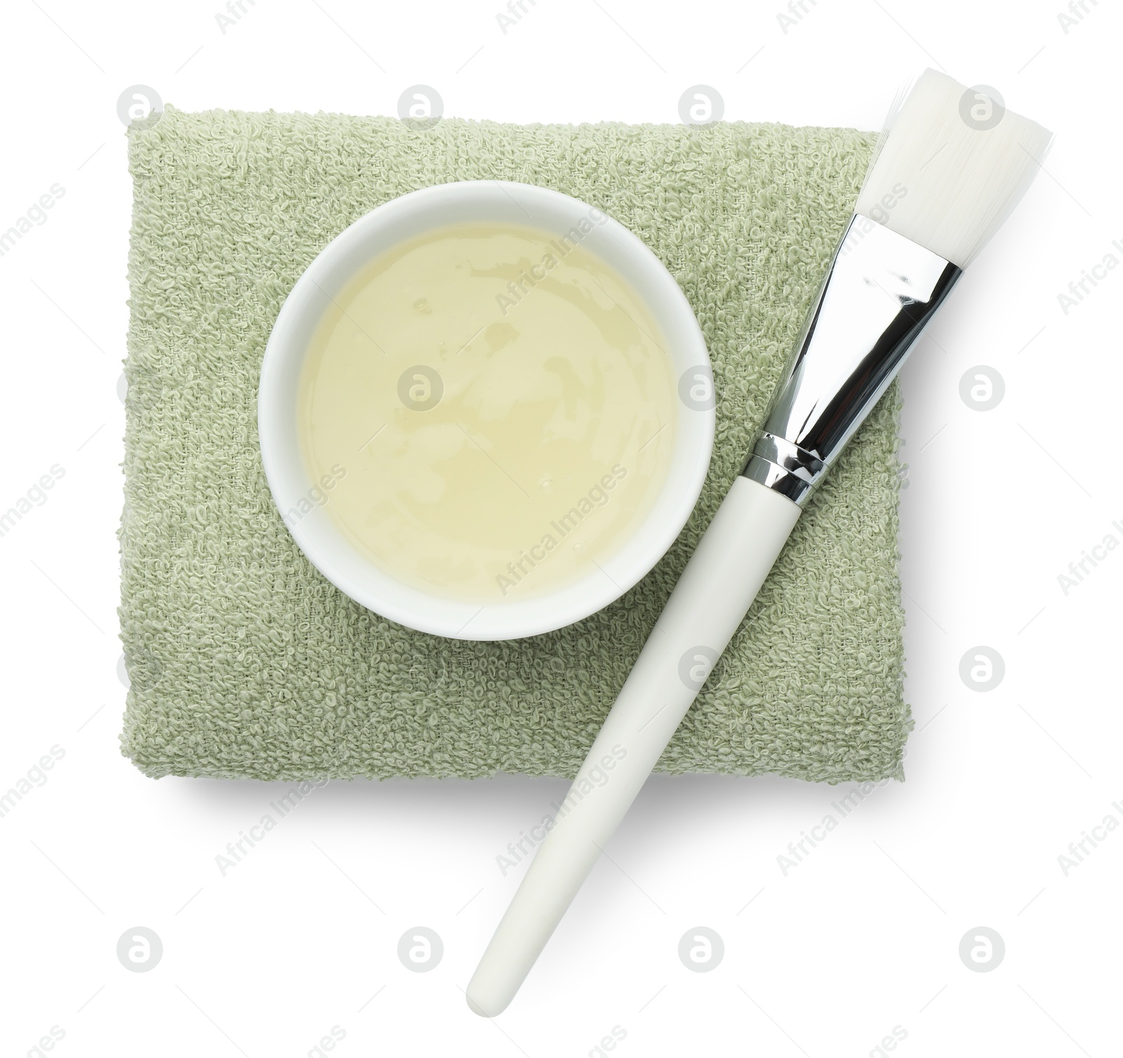 Photo of Bowl of chemical peel, towel and brush isolated on white, top view. Peeling procedure