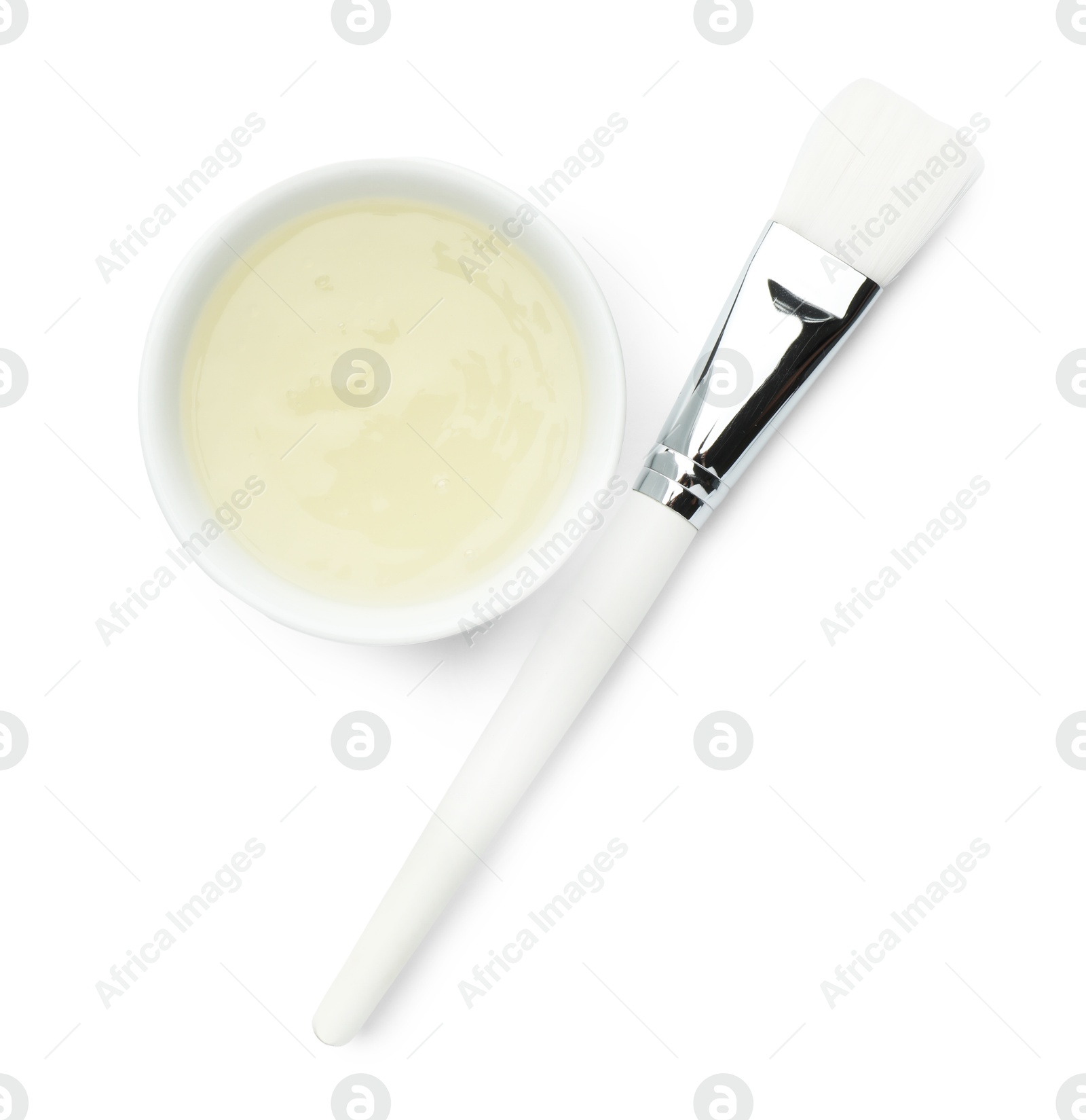 Photo of Bowl of chemical peel and brush isolated on white, top view. Peeling procedure