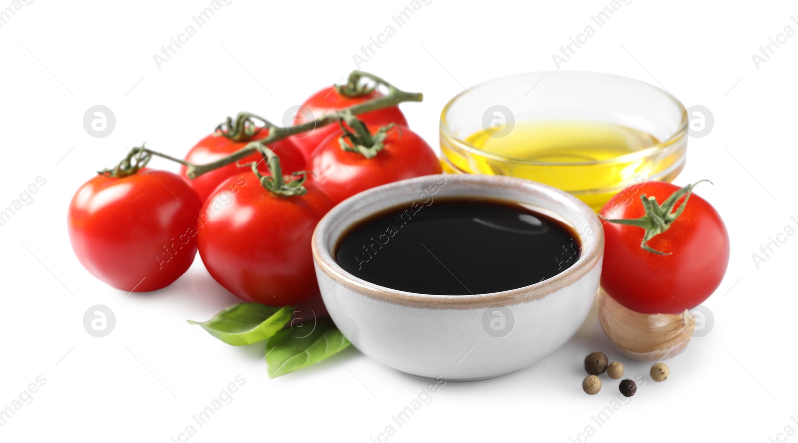 Photo of Delicious balsamic vinegar, olive oil, tomatoes and spices isolated on white