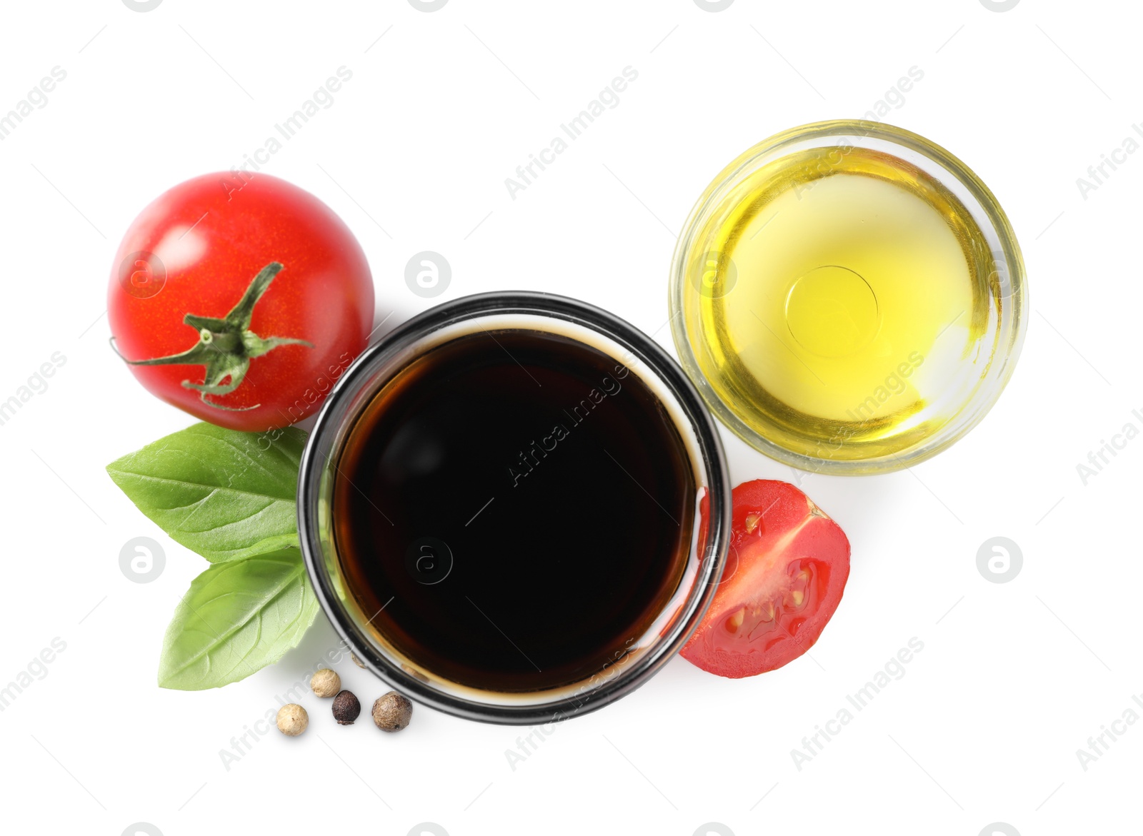 Photo of Delicious balsamic vinegar, olive oil, basil, tomatoes and peppercorns isolated on white, top view