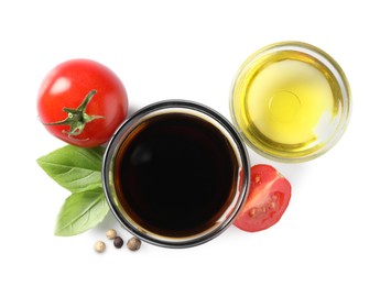 Photo of Delicious balsamic vinegar, olive oil, basil, tomatoes and peppercorns isolated on white, top view