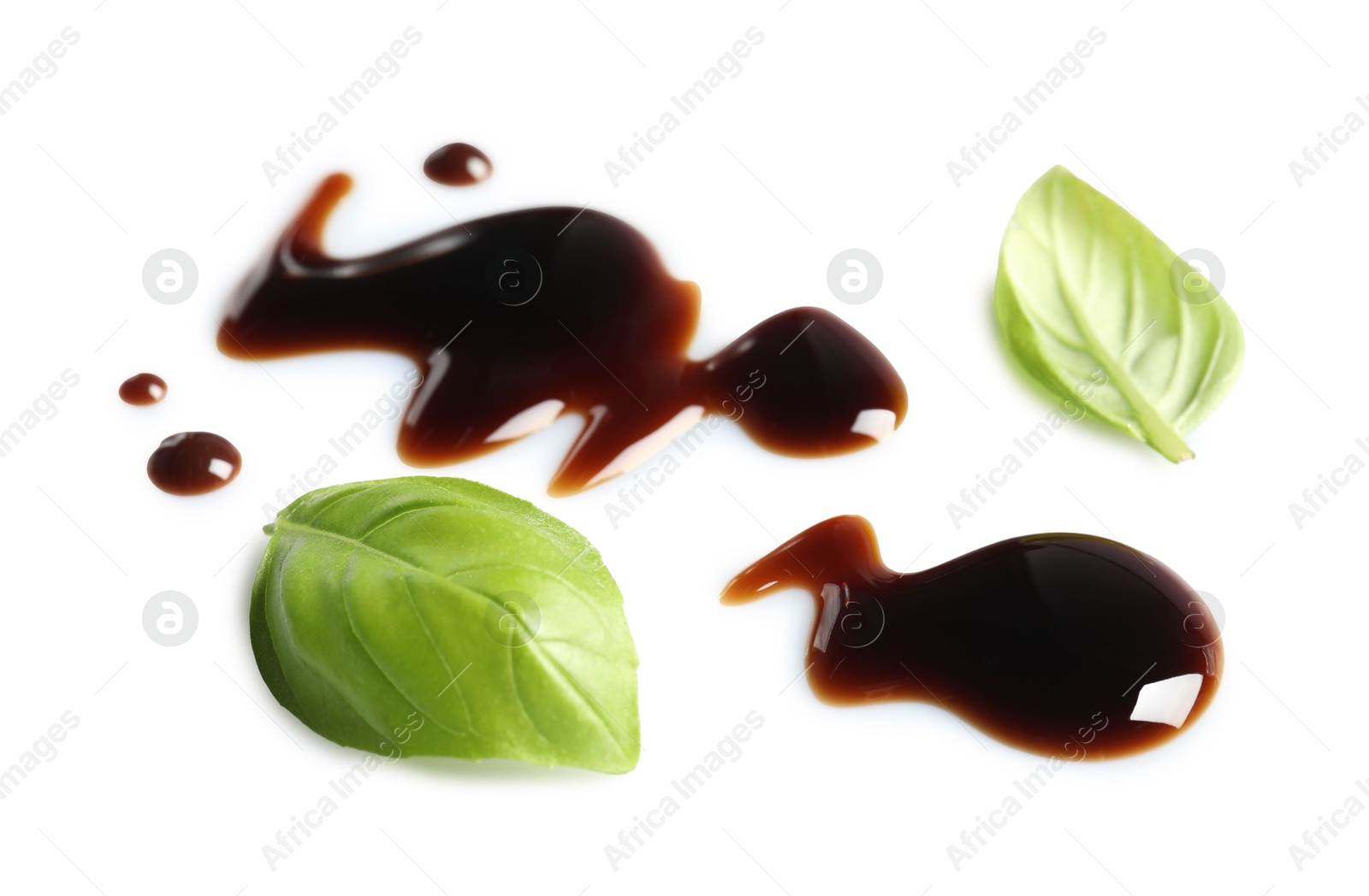 Photo of Delicious balsamic vinegar and basil leaves isolated on white