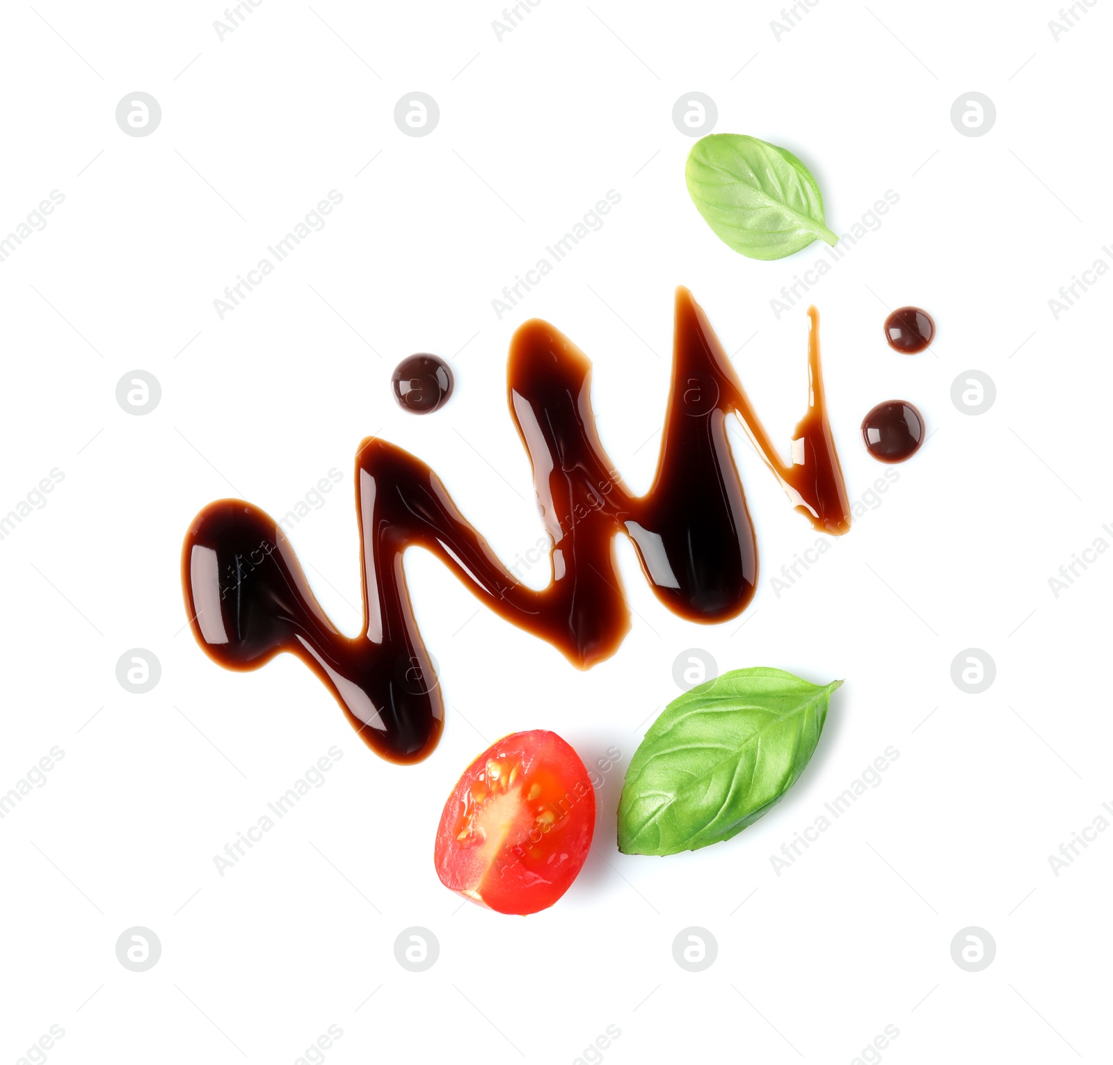 Photo of Delicious balsamic vinegar, cut tomato and basil isolated on white, top view