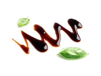 Delicious balsamic vinegar and basil leaves isolated on white