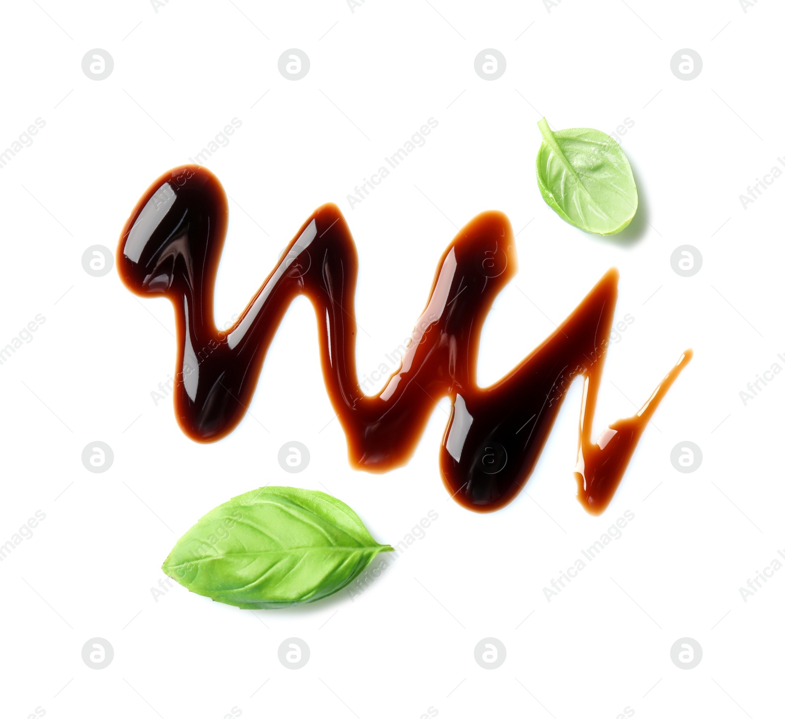 Photo of Delicious balsamic vinegar and basil leaves isolated on white, top view