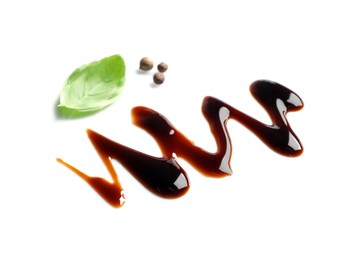 Photo of Delicious balsamic vinegar, basil and peppercorns isolated on white