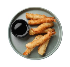 Tasty breaded fried shrimps and sauce isolated on white, top view