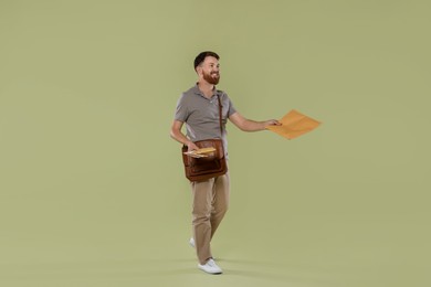 Postman with brown bag delivering letters on light green background