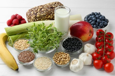 Different fresh products on white wooden table. Source of prebiotics