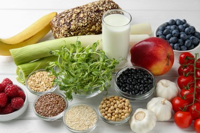 Different fresh products on white wooden table. Source of prebiotics