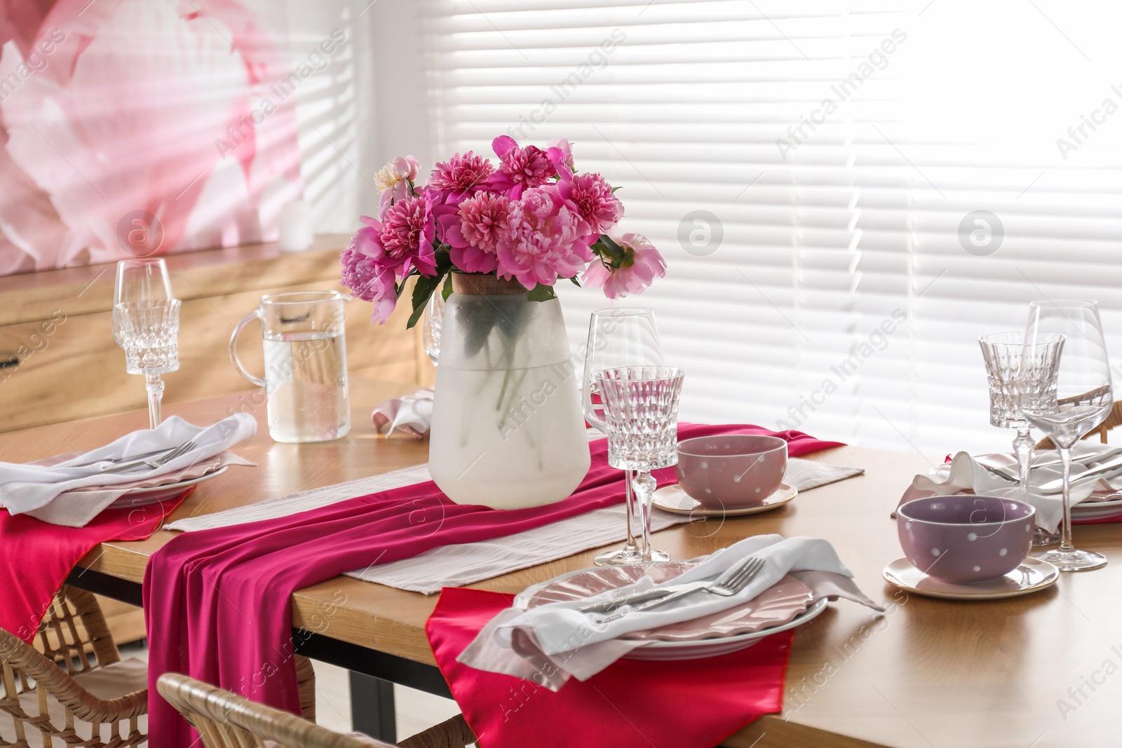 Photo of Beautiful table setting with pink peonies in dining room