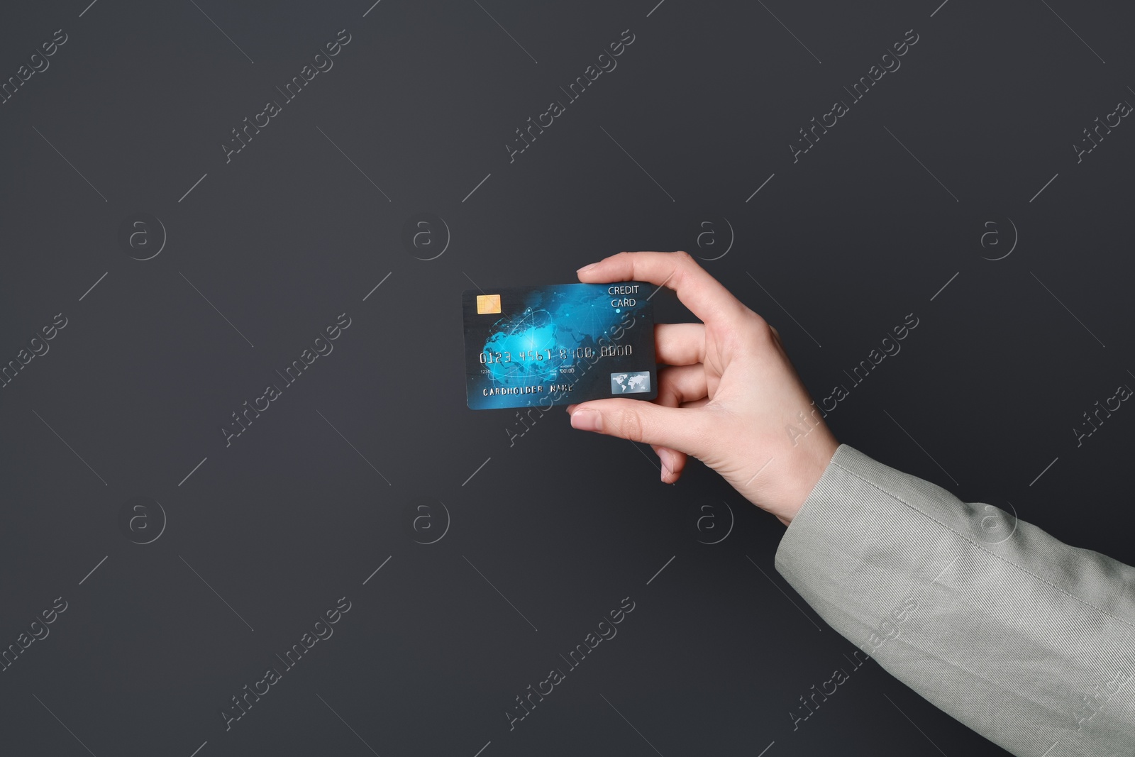 Photo of Woman holding credit card on black background, closeup