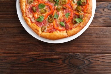 Delicious pizza Diablo on wooden table, top view. Space for text