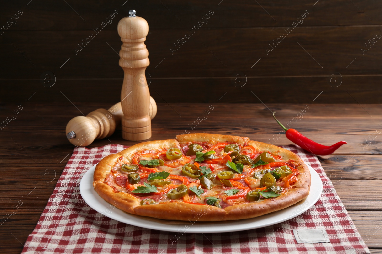 Photo of Delicious hot pizza Diablo on wooden table