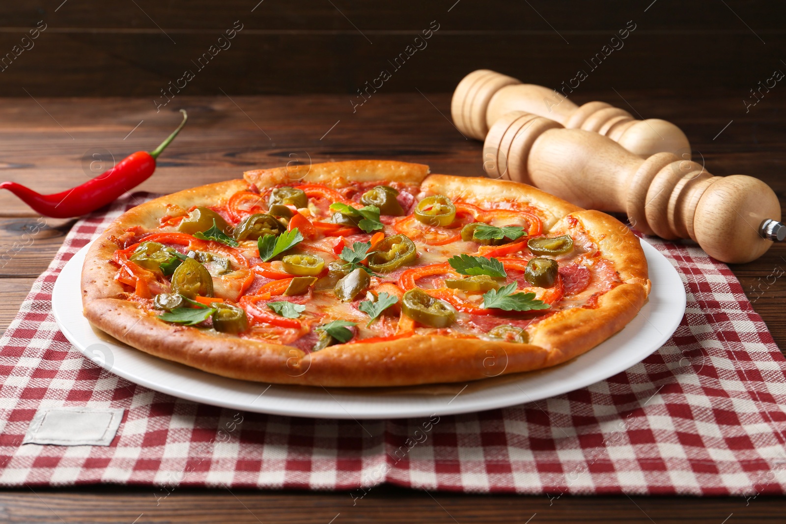 Photo of Delicious hot pizza Diablo on wooden table