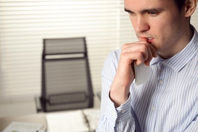 Photo of Embarrassed man in office, space for text