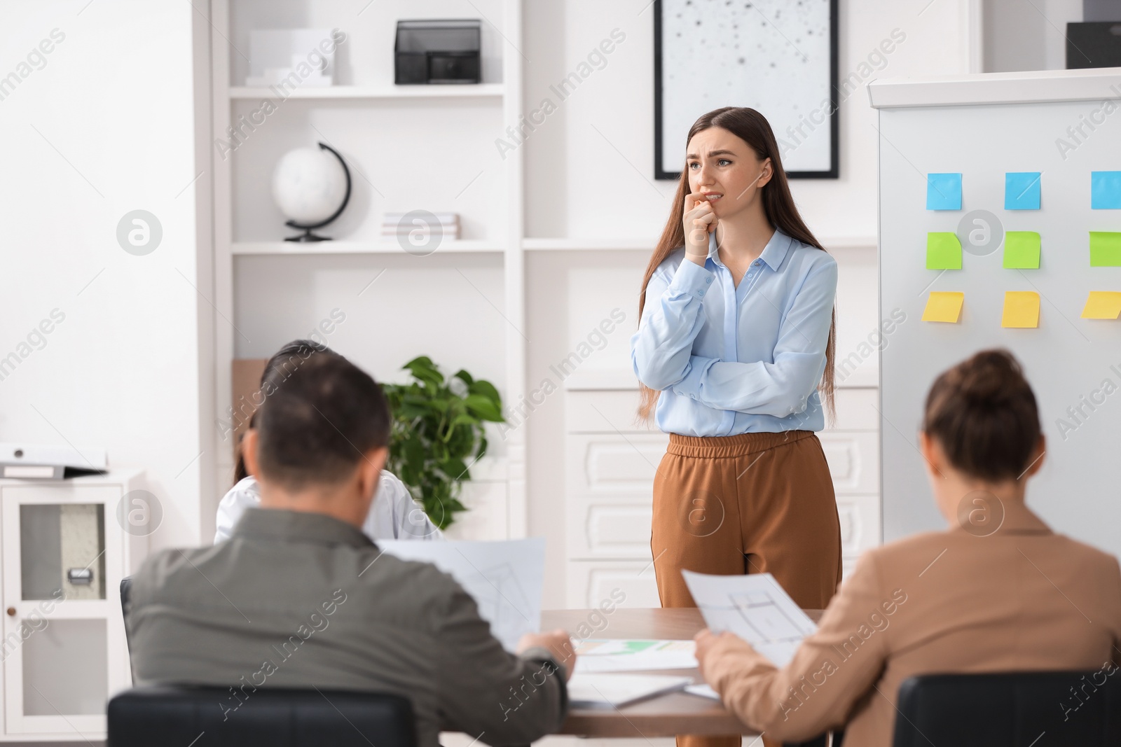 Photo of Woman feeling embarrassed during business meeting in office