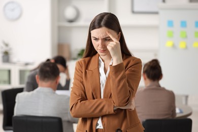 Photo of Woman feeling embarrassed during business meeting in office