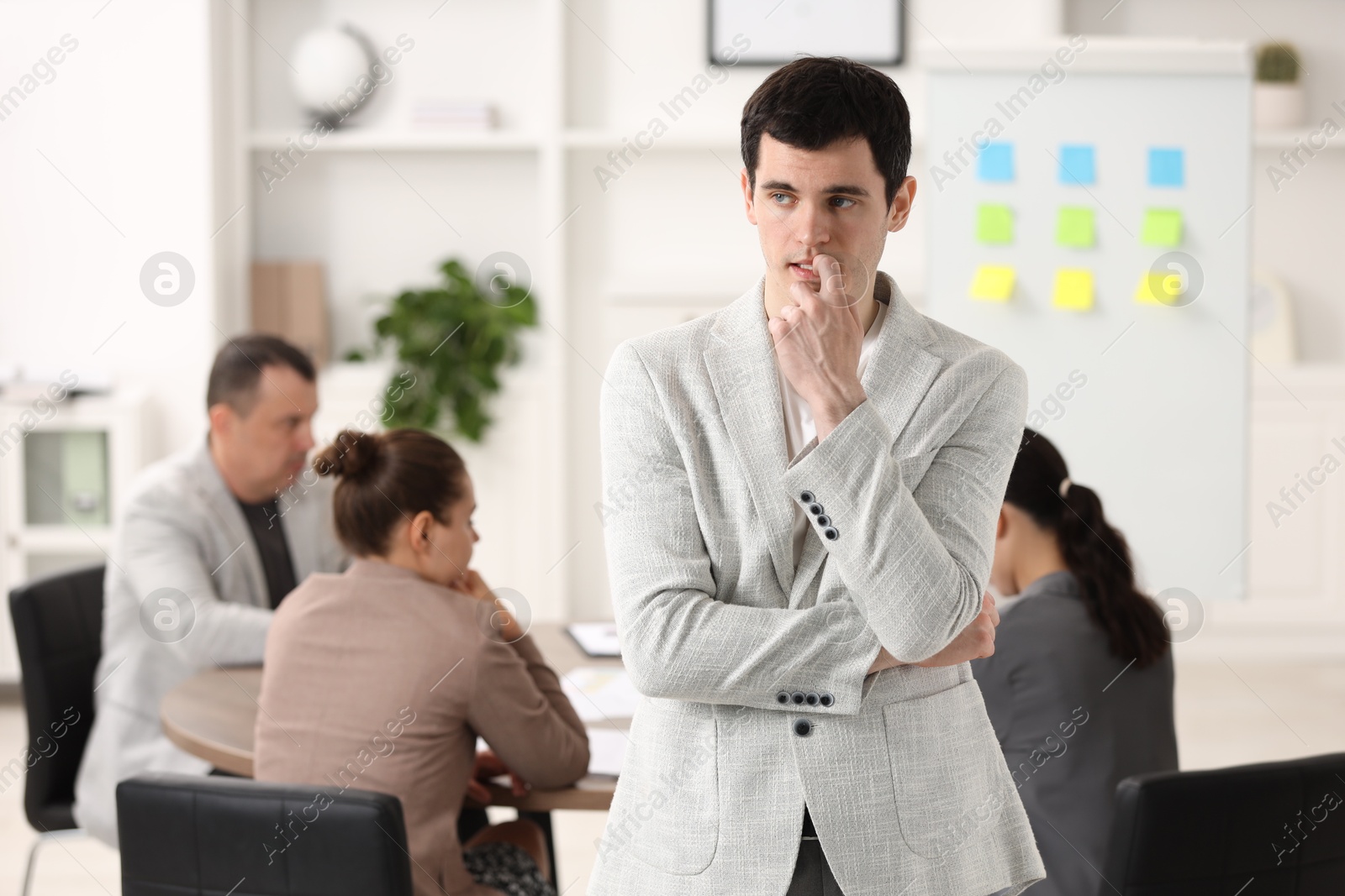 Photo of Man feeling embarrassed during business meeting in office