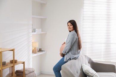 Photo of Portrait of beautiful pregnant woman at home