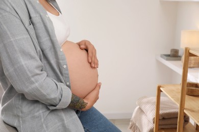 Pregnant woman in living room, closeup view