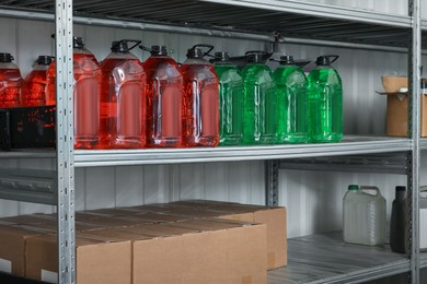 Photo of Different car cleaning products and cardboard boxes in auto store