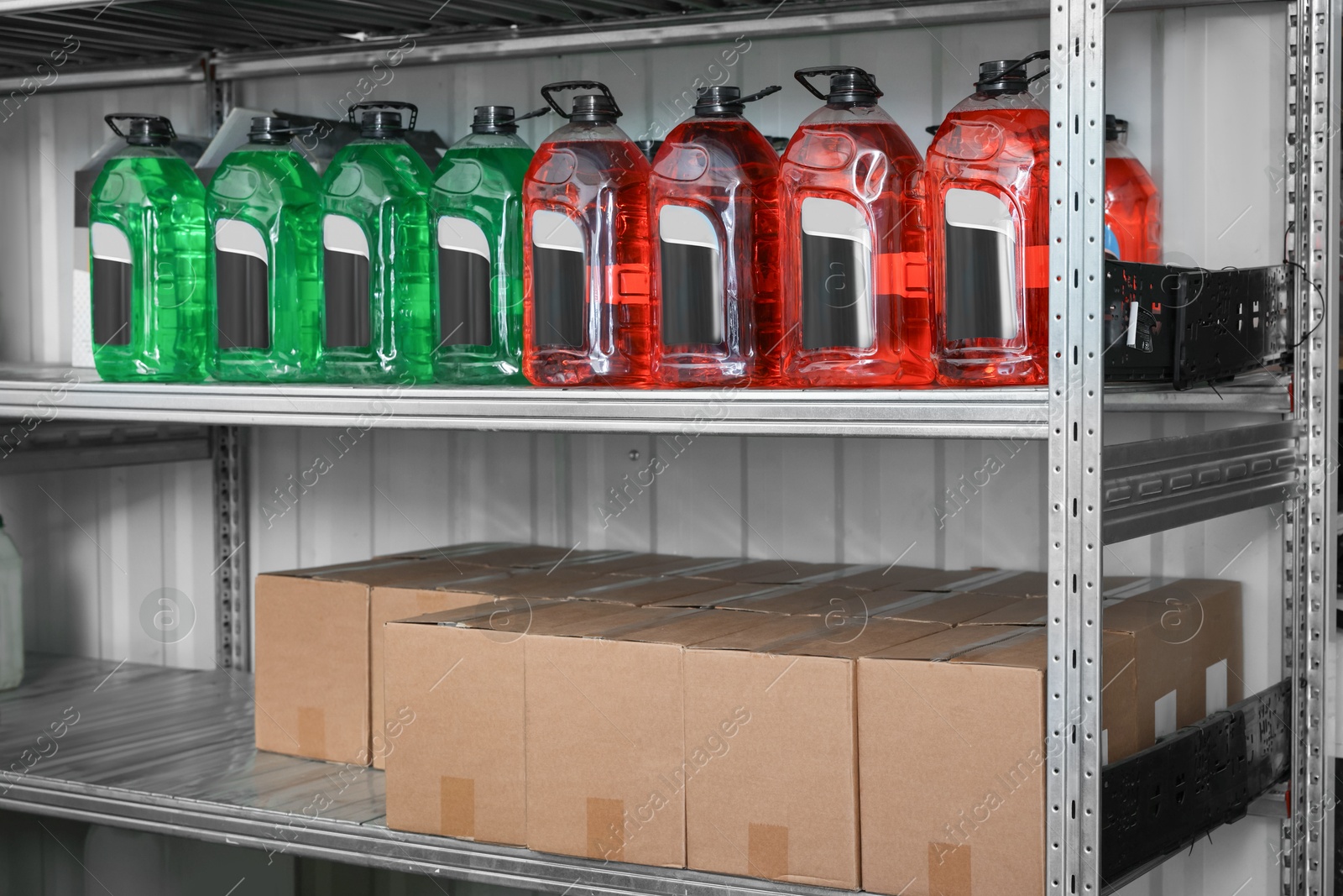 Photo of Different car cleaning products and cardboard boxes in auto store