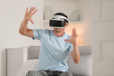 Photo of Man using virtual reality headset at home