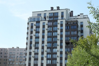 Modern buildings with big windows against blue sky outdoors