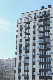 Modern building with big windows against blue sky outdoors