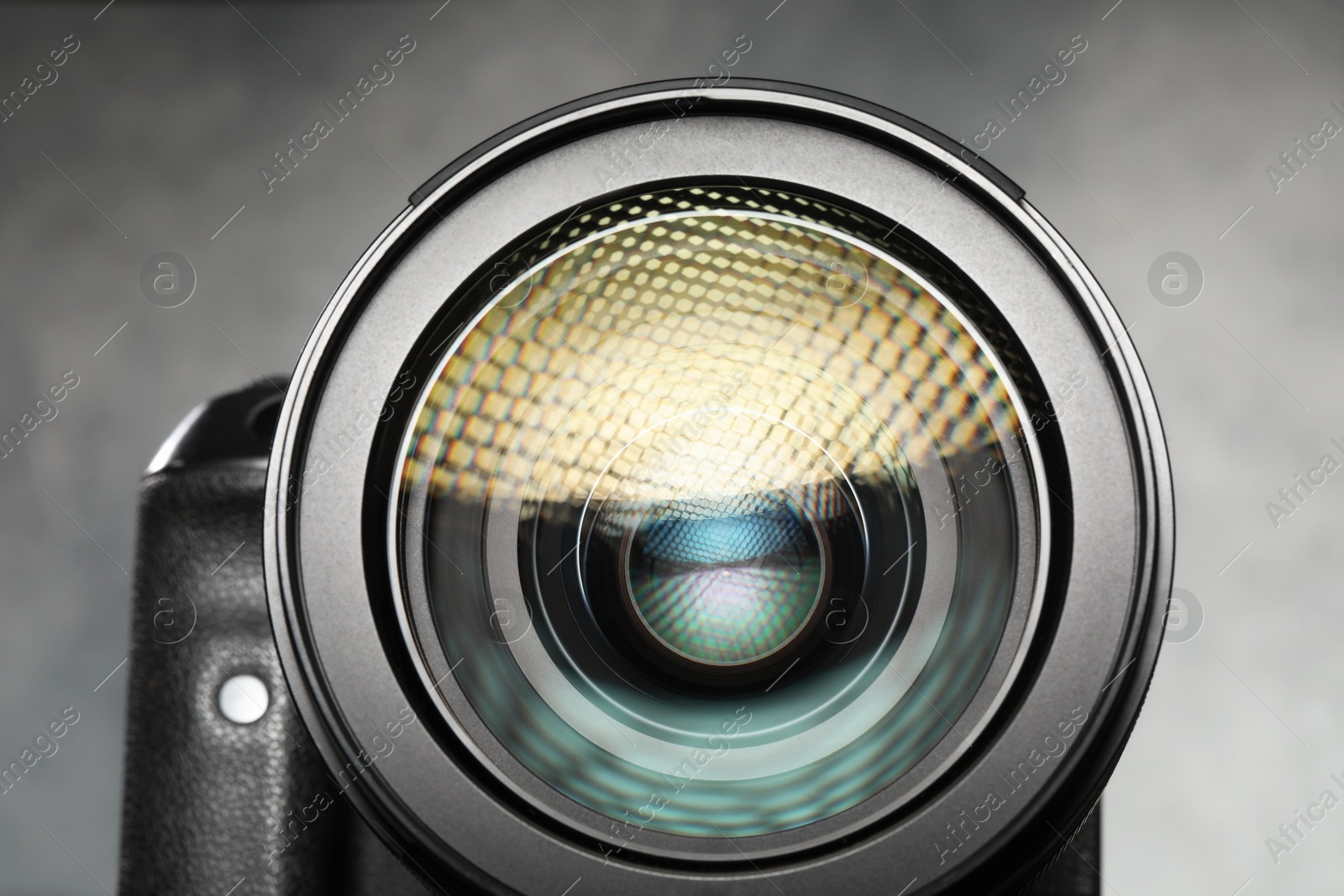 Photo of Modern photo camera on grey background, closeup. Photographer's equipment