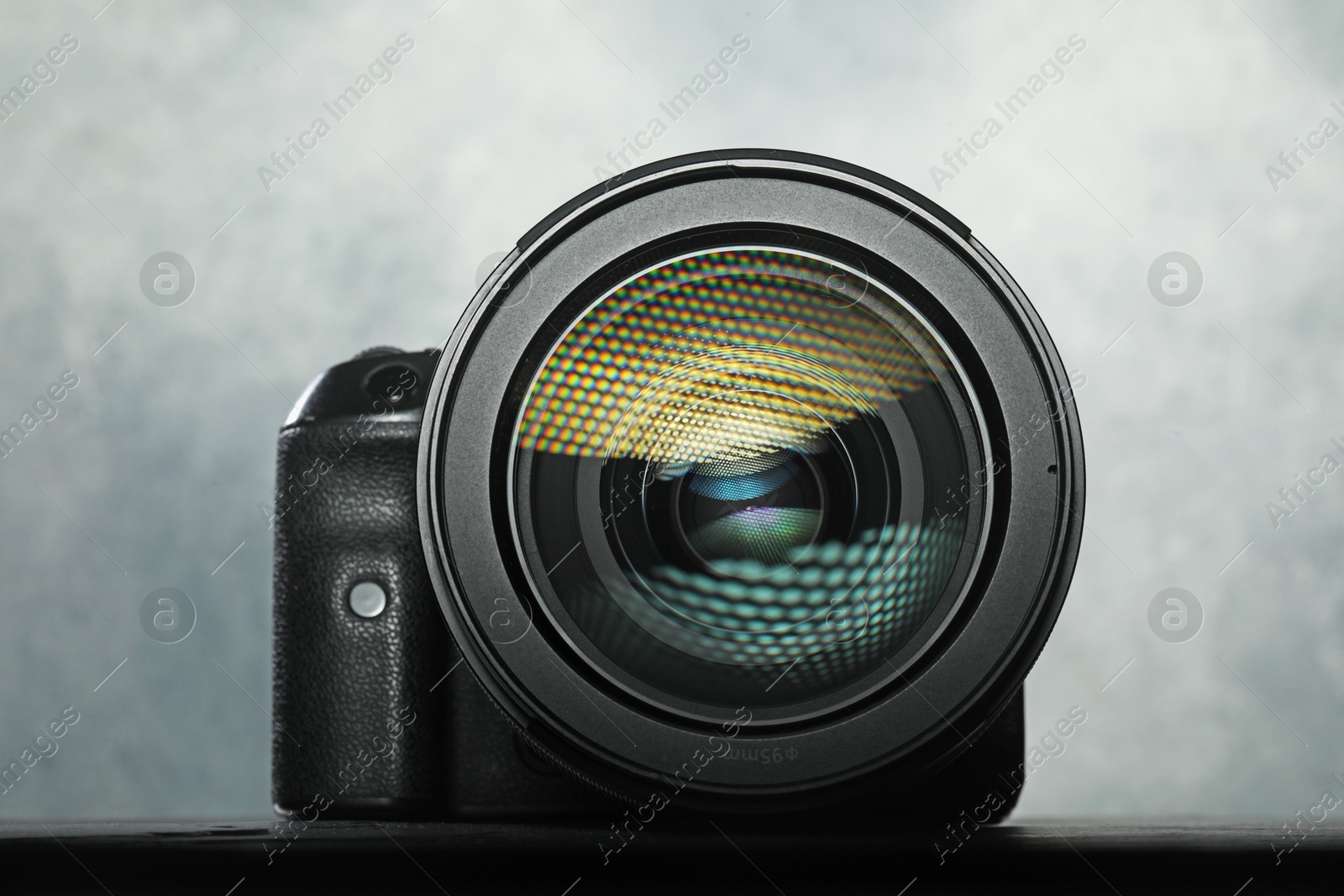 Photo of Modern photo camera on black table. Photographer's equipment