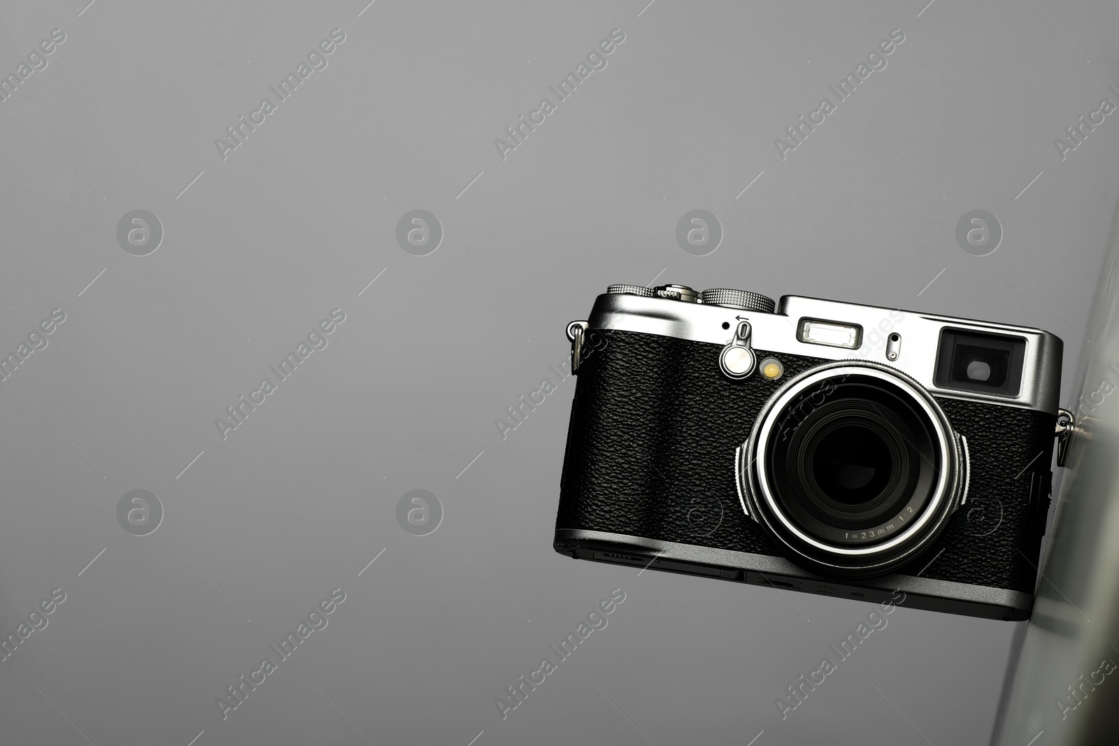 Photo of Vintage photo camera on grey background, top view. Space for text