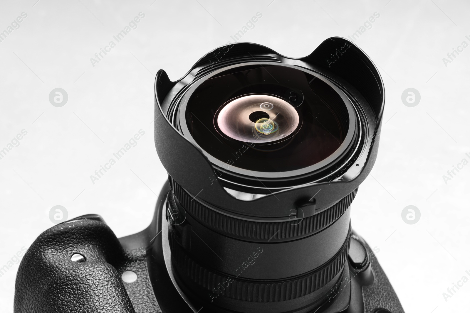 Photo of One modern photo camera on white background, closeup