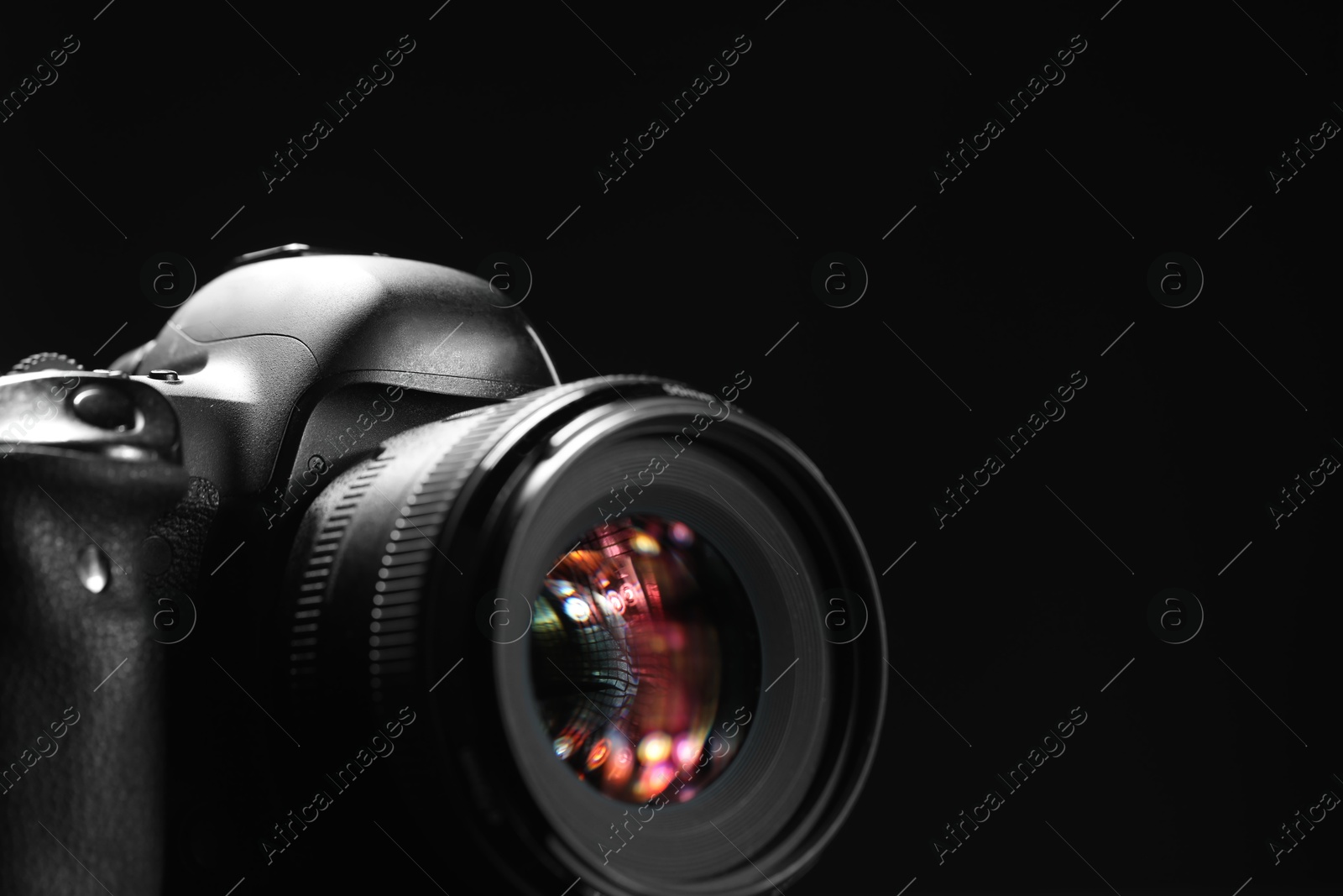 Photo of One modern photo camera on black background, space for text