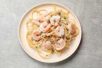 Photo of Delicious pasta with shrimps on grey table, top view