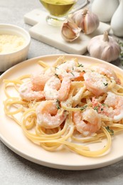 Photo of Delicious pasta with shrimps served on grey table, closeup