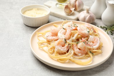 Delicious pasta with shrimps served on grey table, closeup