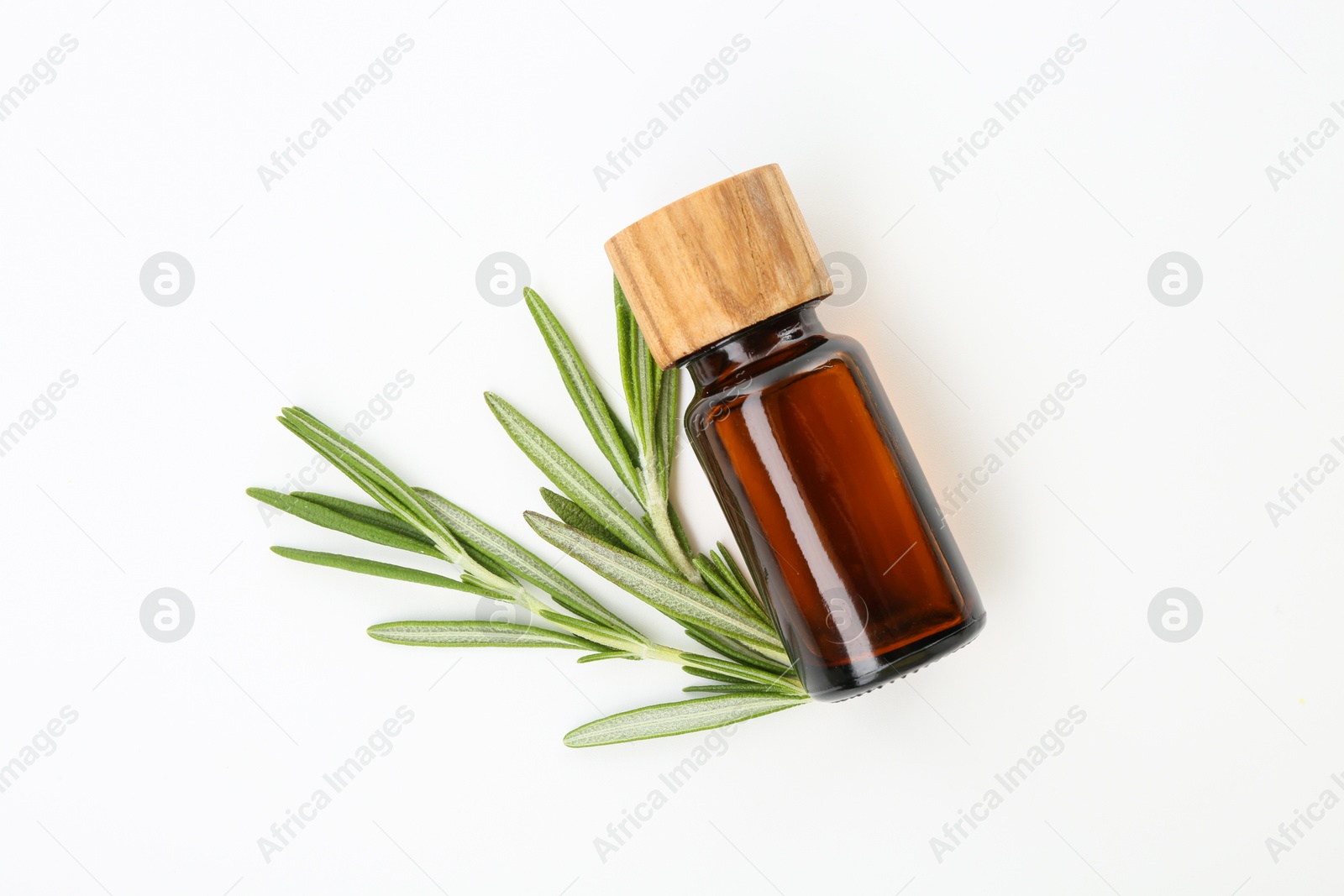 Photo of Bottle of essential oil and fresh rosemary on white background, flat lay