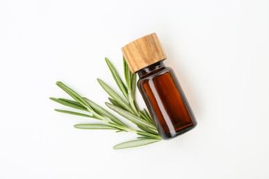 Photo of Bottle of essential oil and fresh rosemary on white background, flat lay