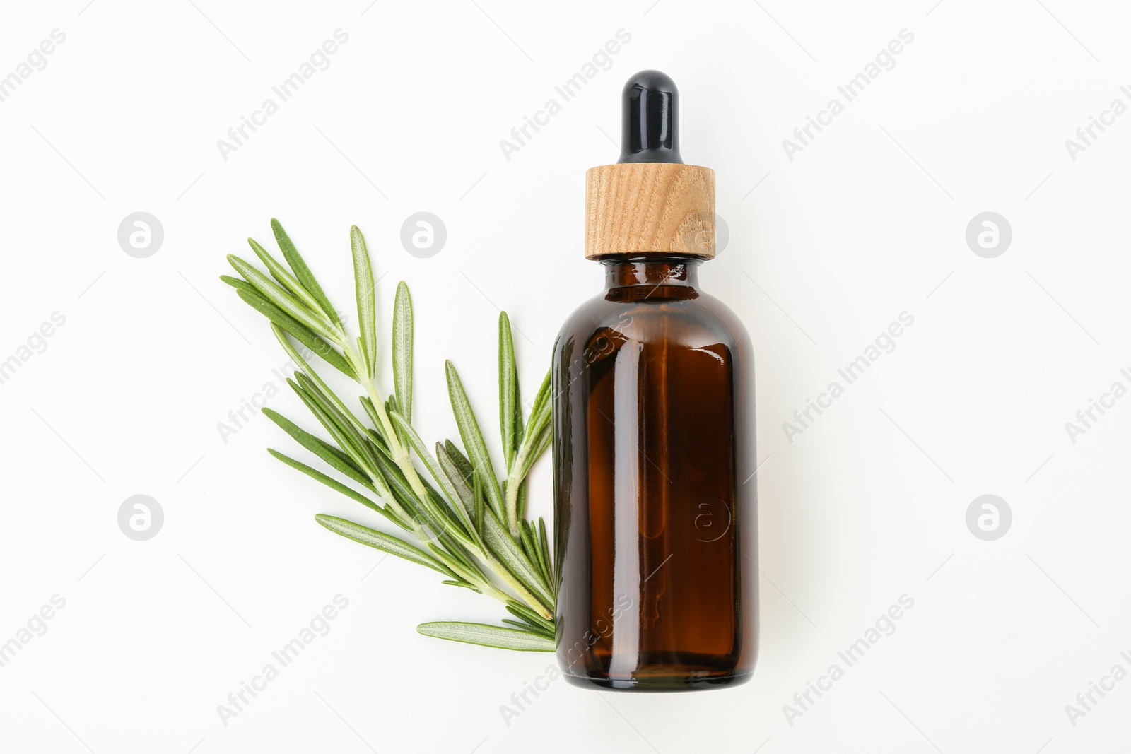 Photo of Bottle of essential oil and fresh rosemary on white background, flat lay