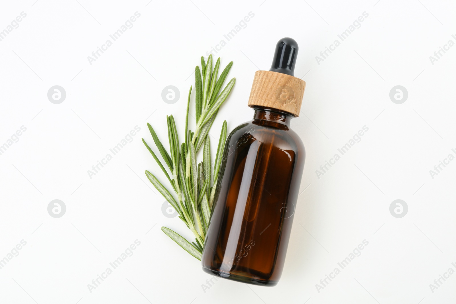 Photo of Bottle of essential oil and fresh rosemary on white background, flat lay