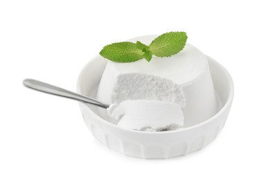 Photo of Delicious ricotta cheese, mint and spoon in bowl isolated on white