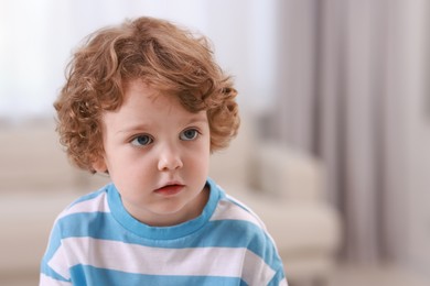 Portrait of little boy indoors, space for text. Cute child