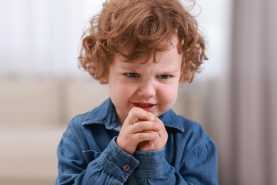 Portrait of emotional little boy indoors. Cute child