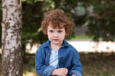 Photo of Portrait of little boy outdoors. Cute child