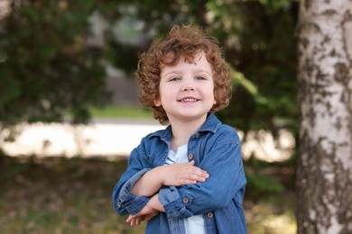 Photo of Portrait of little boy outdoors. Cute child