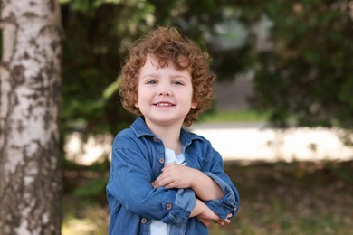 Photo of Portrait of little boy outdoors. Cute child